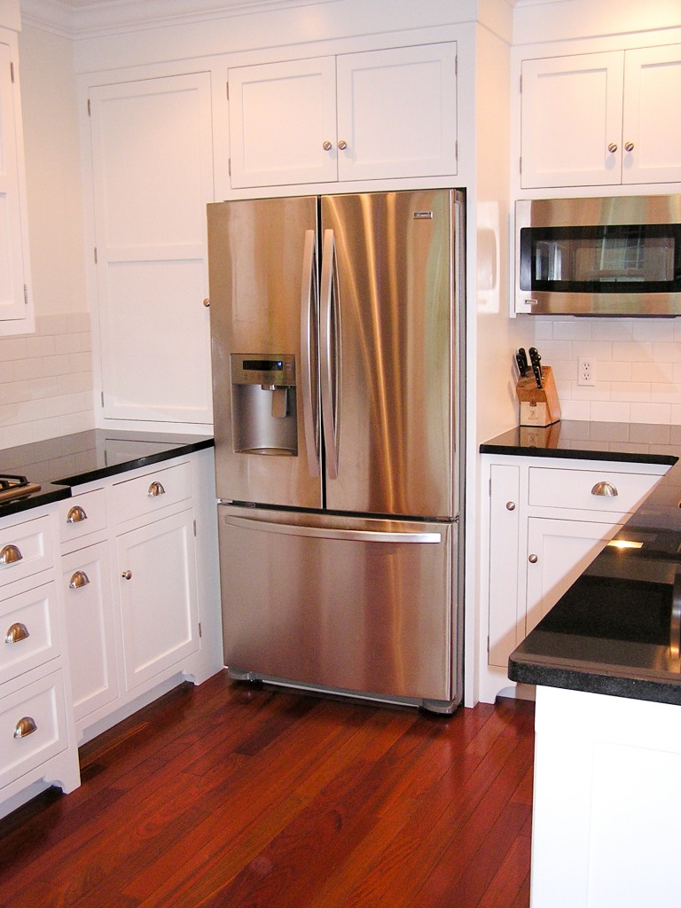 white kitchen, colonial toe kick, bumped out cabinets at stovetop, fancy hood